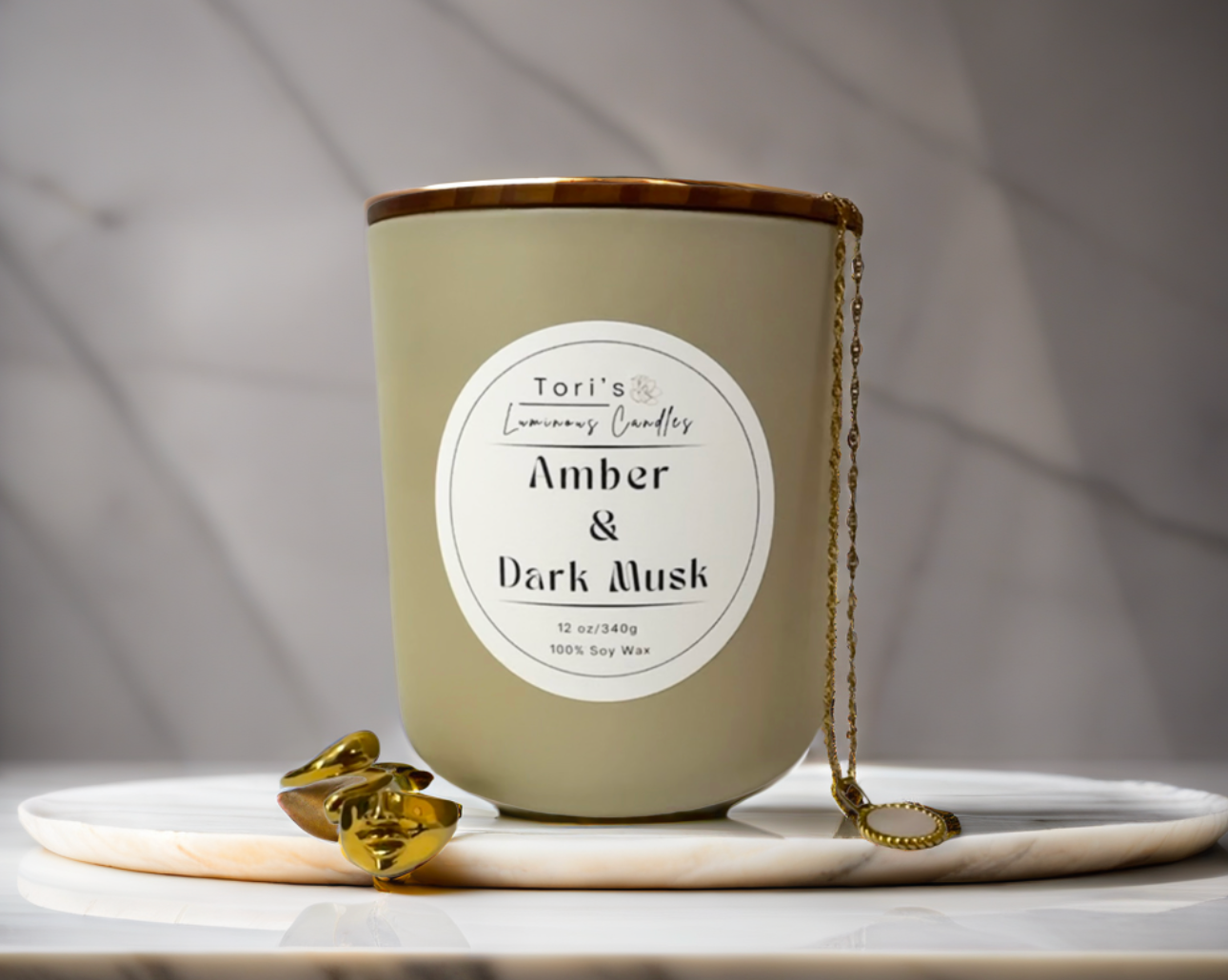 Amber & Dark Musk candle in a frosted amber 8 oz jar and matte cream 12 oz jar, styled on a neutral-toned surface with soft lighting, showcasing the elegant vessels and cozy home décor vibes.