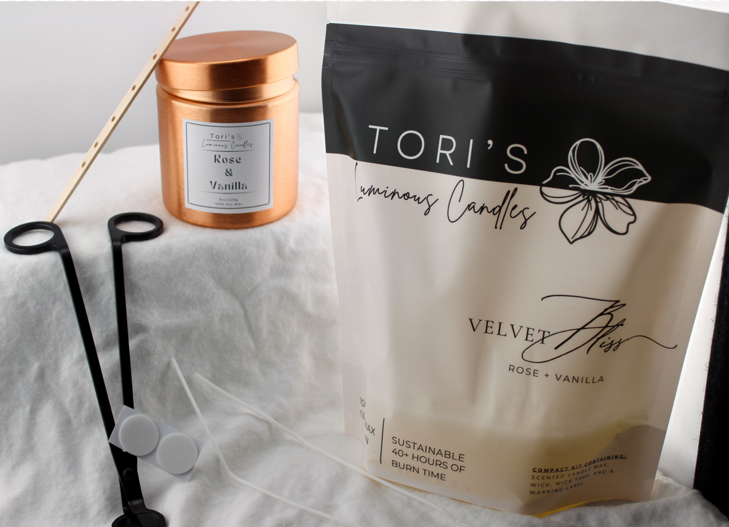 ose and vanilla candle in a sleek 8 oz copper vessel, styled alongside the Rewick & Chill refill kit (with cotton wicks, wick tabs, and prescented soy wax) and wick trimmer—showcasing a classy, sustainable way to enhance your space with serene elegance.