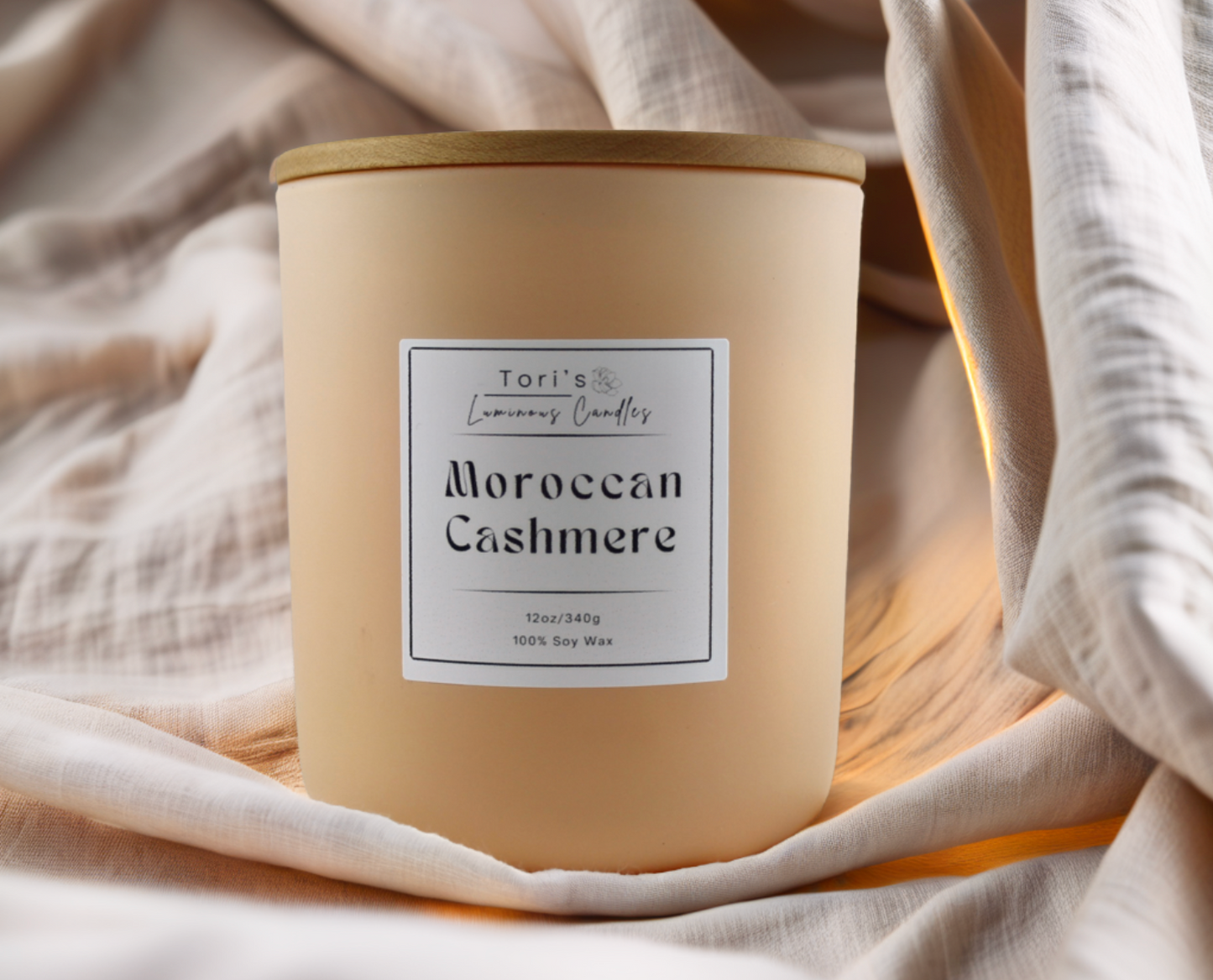 Moroccan Cashmere candle in a 12 oz matte peach jar and 8 oz copper tin, styled in an elegant, minimalist space that reflects the essence of quiet luxury.