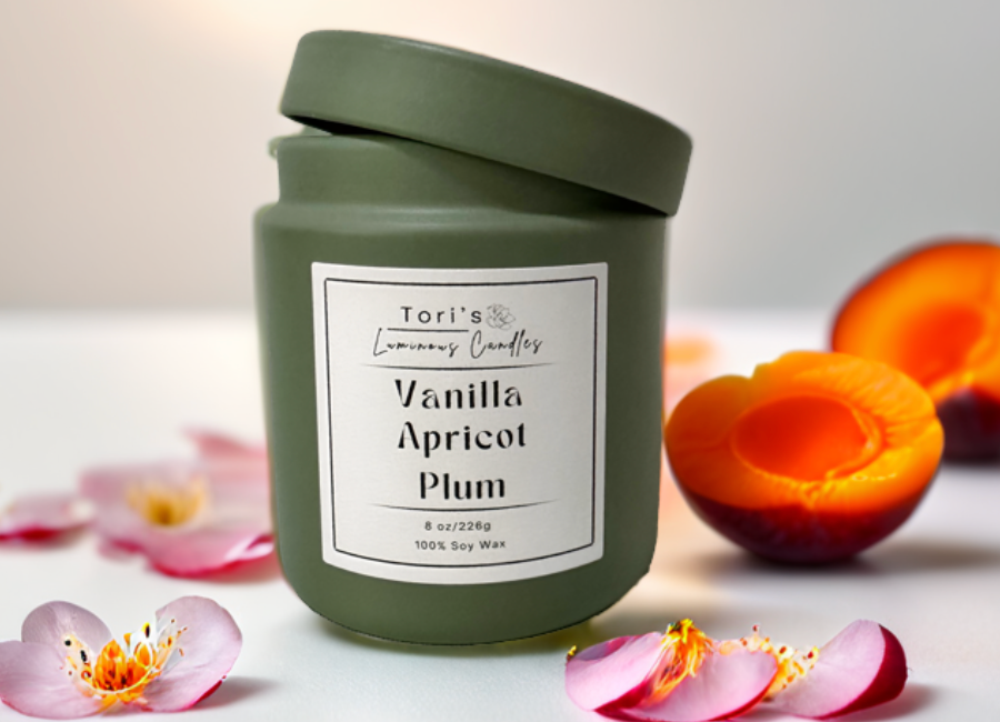 Floral and fruity candle in 8 oz matte sage and 12 oz matte peach jars, styled in a cozy, elegant space—capturing year-round charm and a timeless, classy feel.