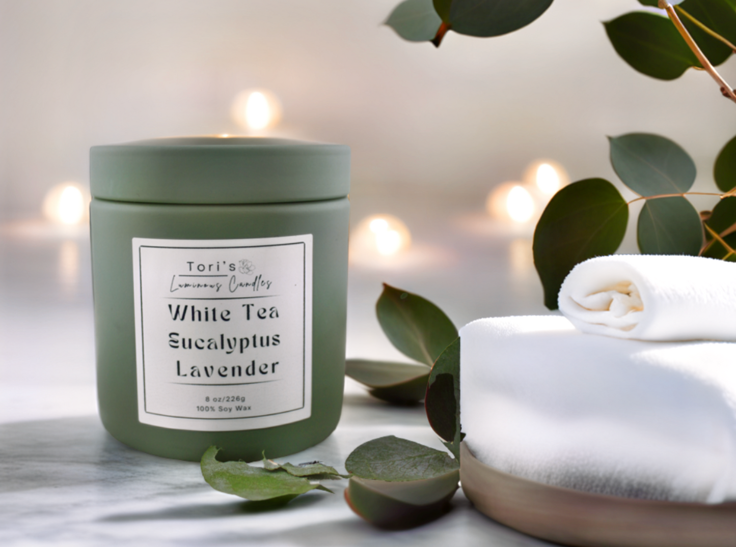 White tea, eucalyptus, and lavender candle in matte sage 8 oz and matte peach 12 oz jars, styled in a peaceful setting with soft lighting—ideal for spa-inspired relaxation at home or in a salon.