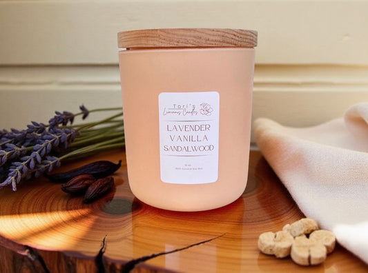 12oz Lavender, Vanilla & Sandalwood candle in a matte cream jar, surrounded by soft home décor accents, evoking a calm and cozy atmosphere.