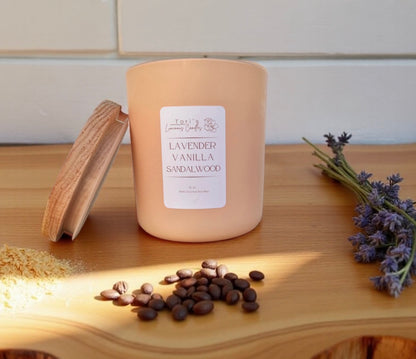 12oz Lavender, Vanilla & Sandalwood candle in a matte cream jar, surrounded by soft home décor accents, evoking a calm and cozy atmosphere.