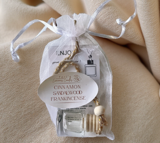 Cinnamon, Sandalwood, and Frankincense car diffuser creating a warm and cozy aromatic atmosphere in a car interior