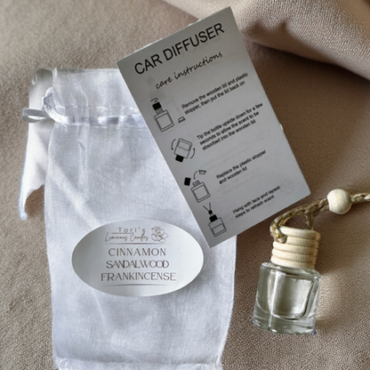 Cinnamon, Sandalwood, and Frankincense car diffuser creating a warm and cozy aromatic atmosphere in a car interior