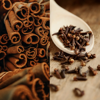 cinnamon and clove soy candle styled with cinnamon sticks, whole cloves, and warm neutral textures, creating a cozy, spiced holiday atmosphere.