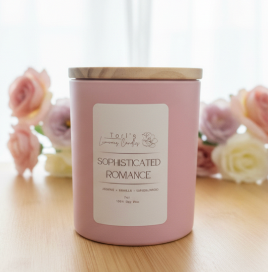 A luxury candle titled 'Sophisticated Romance' in a minimalist glass jar. The label is clean and modern, listing notes of Jasmine, Vanilla, and Sandalwood. The candle is styled on a marble surface next to a sprig of dried jasmine and a sandalwood incense stick.