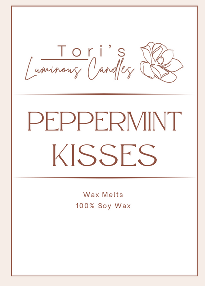 Peppermint Kisses candle lit on a clean winter-themed surface, surrounded by red-and-white peppermint candies and soft eucalyptus sprigs. The flame glows brightly, creating a fresh, uplifting holiday feel reminiscent of candy canes and winter air.