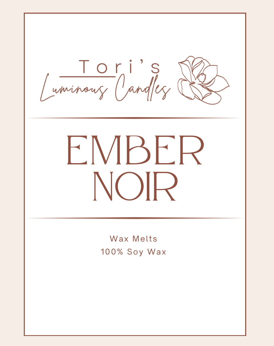 A warm, rustic candle labeled “Fire Ember + Sweet Tobacco,” surrounded by elements like smoldering wood, dried tobacco leaves, and a soft amber glow. The imagery evokes a smoky cabin fire, rich sweetness, and an earthy, atmospheric warmth.